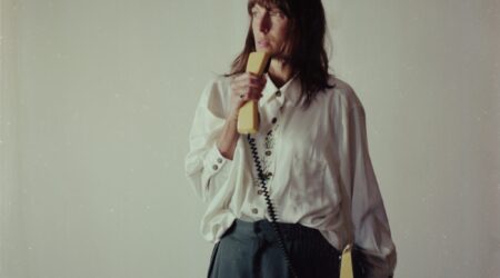 Photograph of a dancer holding a yellow telephone